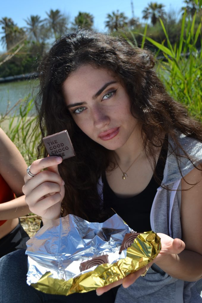 A woman showing the Bar of The Good Chocolate