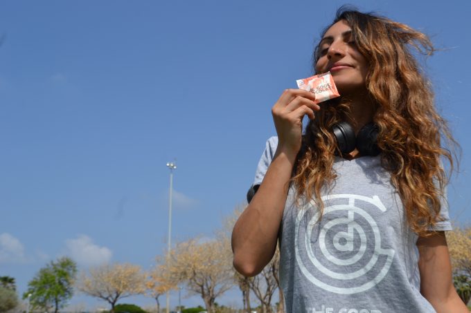 Woman who wore the Good Chocolate's T-shirt With Logo and Showing The Good Chocolate's Salted Almond Square pack